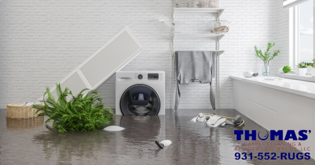 This photo shows a room containing a washing machine and items from home that has flooded, with water standing and items floating in water.